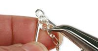 Pliers holding a jump ring